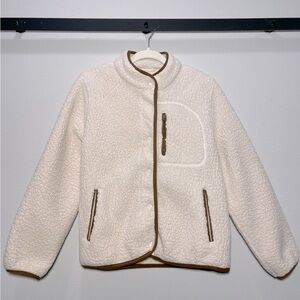 Cream sherpa fleece jacket with brown lining.